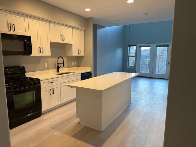 Kitchen view into living room and balcony - 5 S 500 W Unit Parc at the Gateway