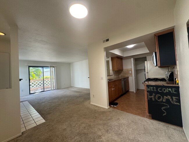 Kitching, living room, and balcony/patio - 9408 Twin Trails Dr Unit 106