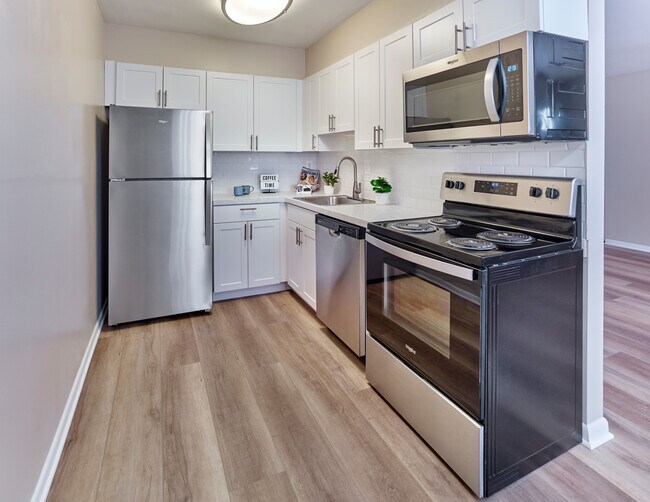 Contemporary kitchen with stainless steel appliances at Village Square.
