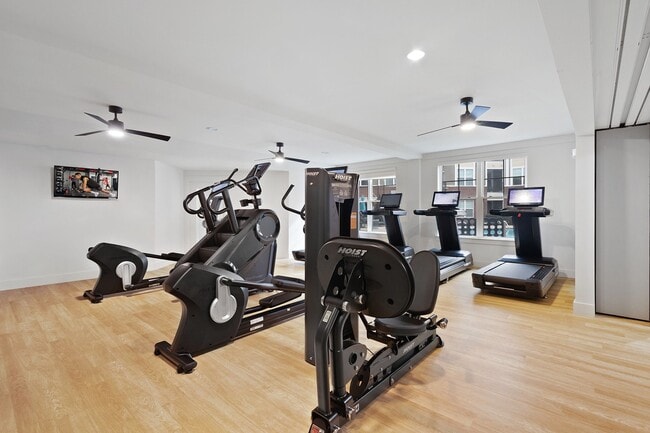 24/7 fitness center with designated cardio and strength areas