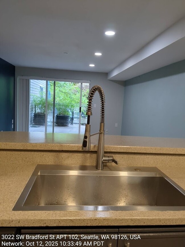 From Kitchen look out to Living room and Patio - 3022 SW Bradford St Unit 104