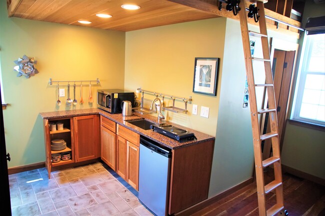 Kitchen before shelving was installed, convection microwave oven, full fridge by entrance door - 69 S Shannon Ave Unit Studio