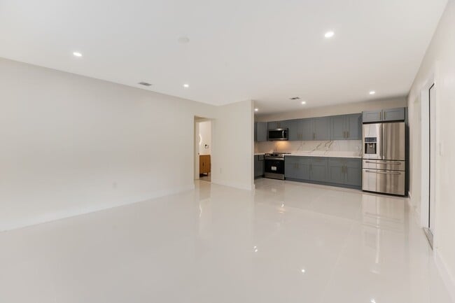Photo - Fully renovated stylish 3 bed 2 bath home featuring a luxury kitchen, modern appliances on a fenc...