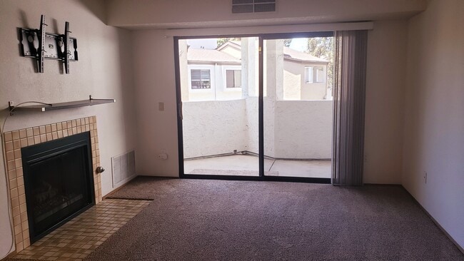 Living room with fireplace and sliding door - 9715 Mesa Springs Way Unit 203