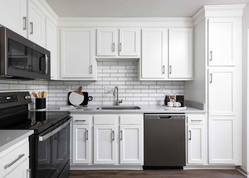 Modern kitchen with slate appliances and white cabinetry