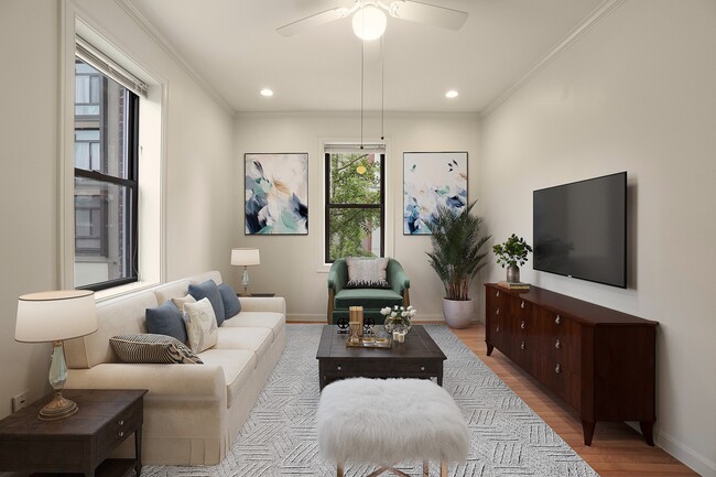 Living room with elegant decor, featuring a cozy beige sofa, lush greenery, modern artwork, and a sleek wall-mounted TV.