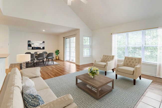 Renovated Package I living and dining area with hard surface flooring - Avalon at The Pinehills