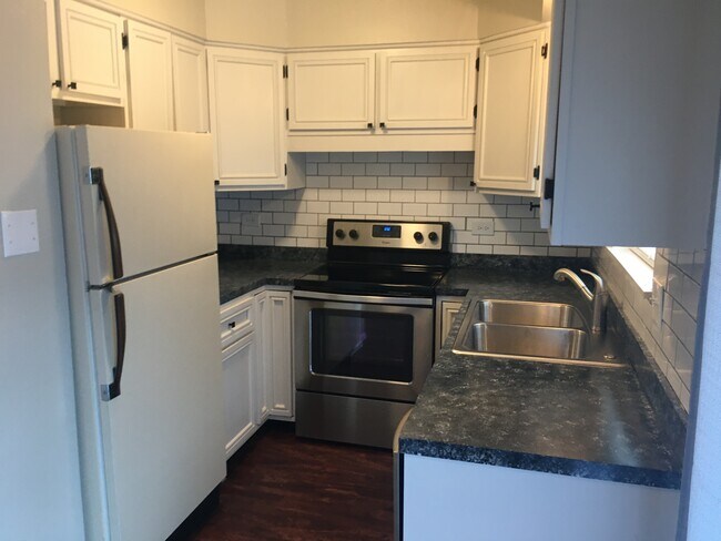 Kitchen with stainless appliances and subway tile - 4715 SE Adams Blvd Unit 909-C
