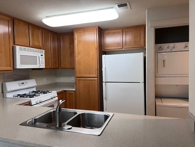 Photo - Gated condo with 1 car garage and community pool.