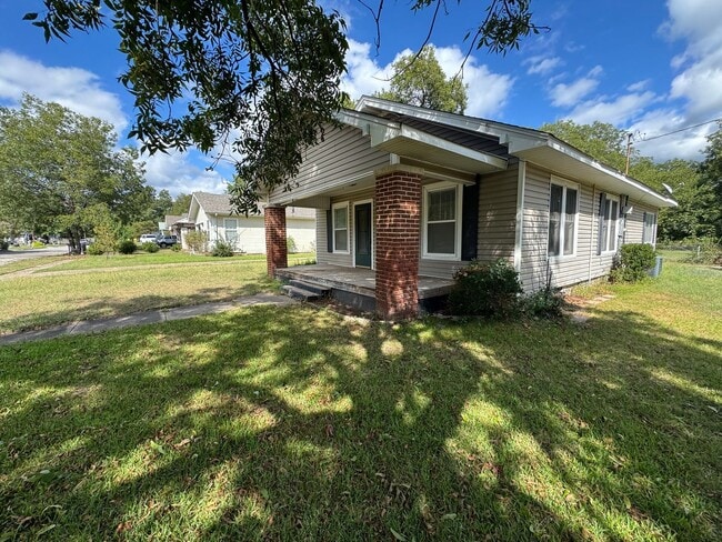 Building Photo - Three bedroom two bath home with central heat and air, large fenced backyard, and carport!