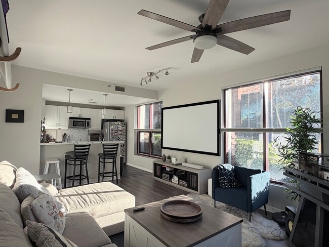 Well lit living room. Versatile custom blinds throughout home to choose any level of privacy. - 1150 J St Unit 107