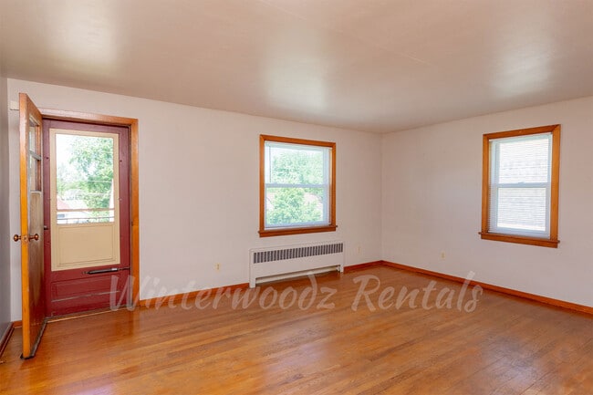 Living Room w/ Door to Shared Balcony - 1432 Porlier St