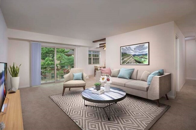 Spacious living area with large balcony at Deerfield Run & Village Square North Apartments