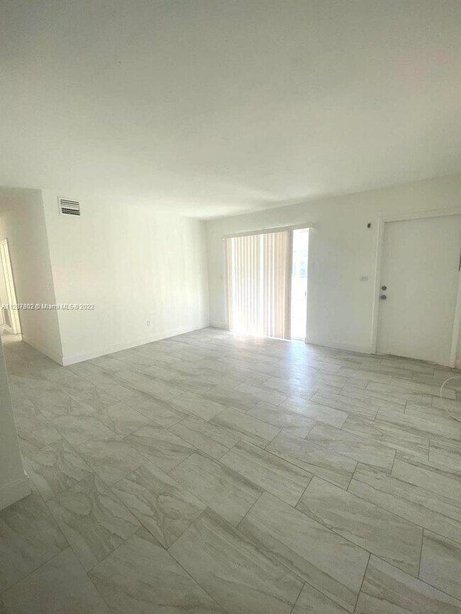 Photo - Updated 3-Bed/2-baths Home with Screened Porch & Lush Yard in Pompano Beach Highlands