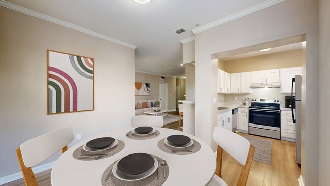 Open floorplan kitchen with stainless steel appliance package - Reflections on Sweetwater Apartments