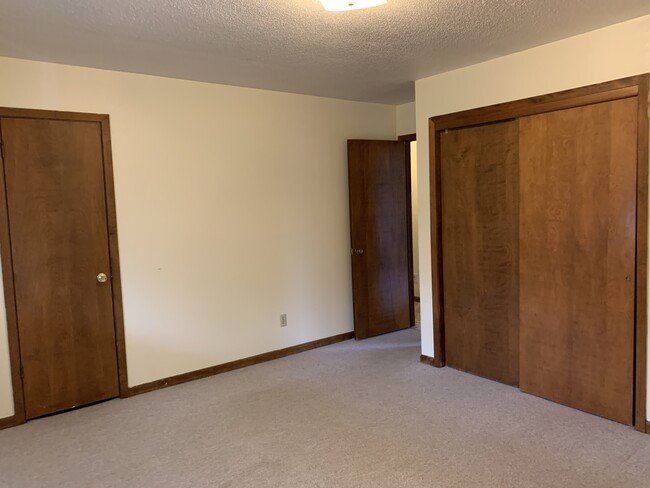 Master bedroom includes 2 closets - 1 is a walk-in with built in shelves. - 1320 5th St W Unit Brick 2-bedroom Townhomes