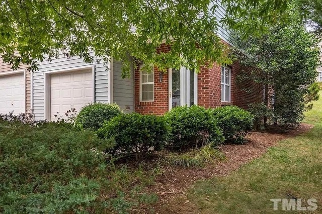 End unit front door with side yard and garage - 245 Plaza Dr