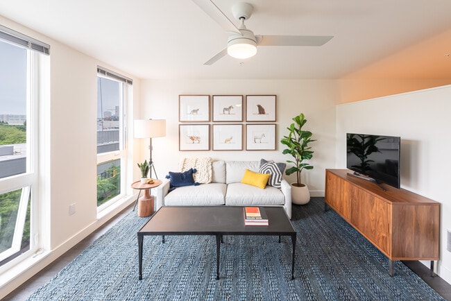 Living Room with Floor to Ceiling Windows and a Ceiling Fan