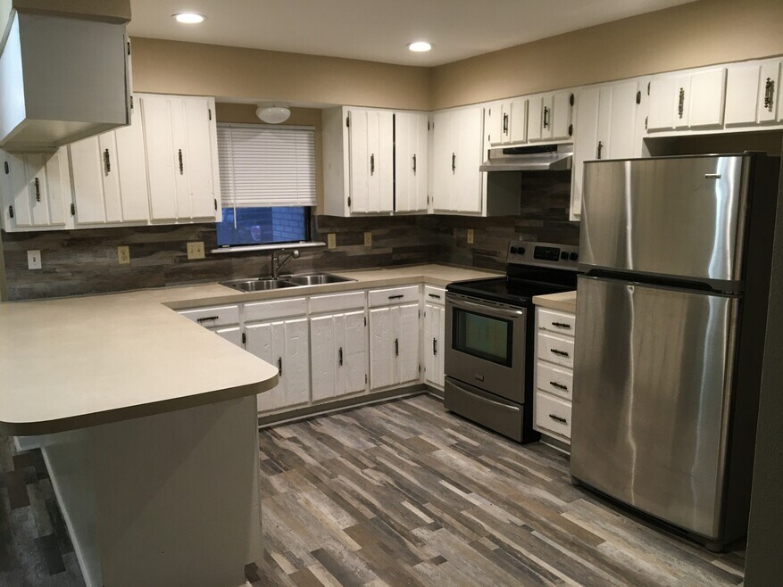 Large open kitchen with lots of cabinets and countertops
