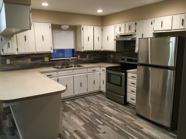 Large open kitchen with lots of cabinets and countertops