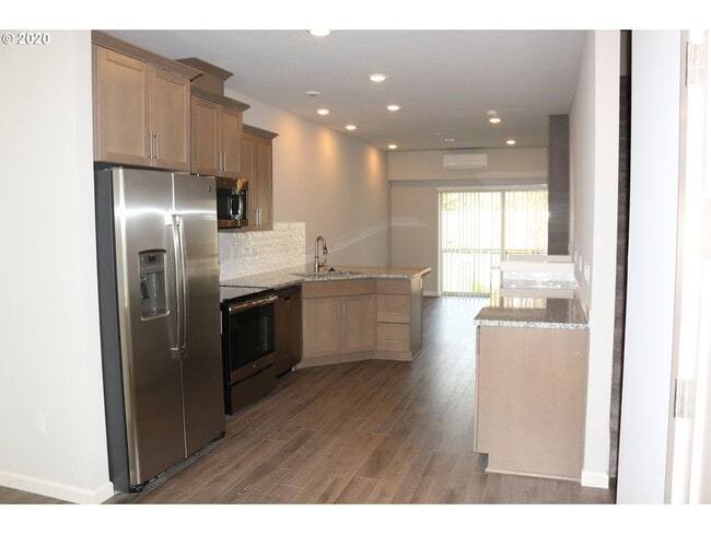 Photo - Modern 3-Bedroom Townhome-Style Home with Attached Garage, Private Patio & En-Suite Bathrooms in ...