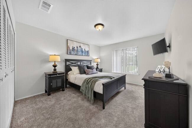 Cozy bedroom with ample storage space at Drawbridge Apartments in Harrison Township, MI. - Drawbridge Apartments East