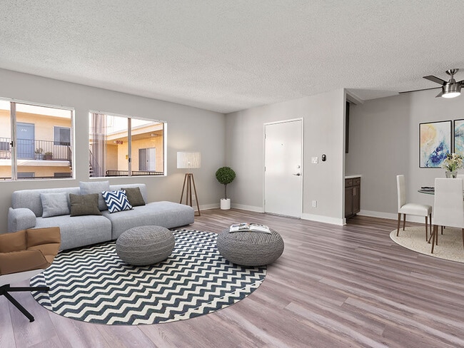 Living room with hardwood floor and view of dining area.