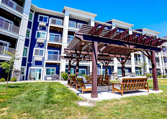 Amenities include an outdoor lounge under a pergola.