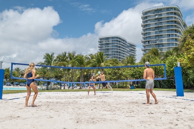 Gather with friends for a game of beach volleyball beside the crystal lagoon.