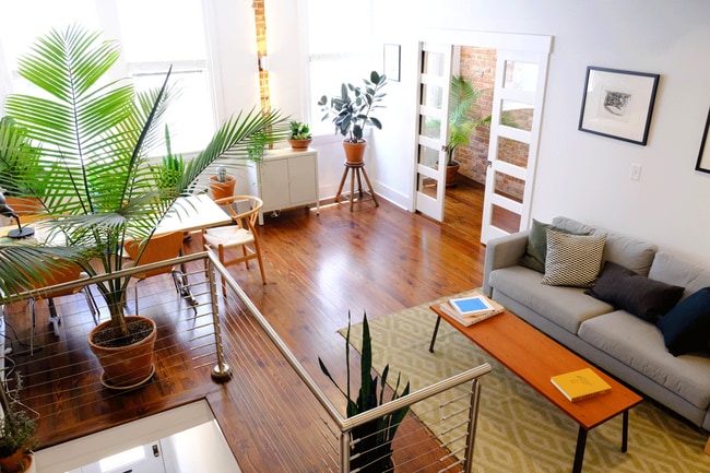 Beautiful light when you come up the stairs into the living area. - 18 W State St Apartment Unit Historic Industrial Brick-walled Beauty