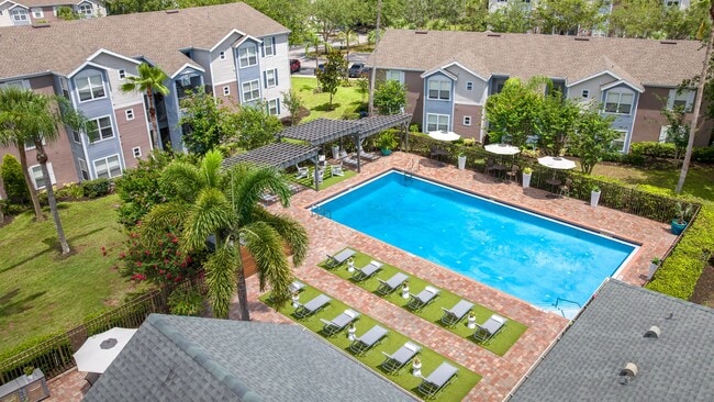 Enjoy every sunny Florida day from our sparkling pool, complete with lounge seating and a relaxing atmosphere. - Ashton Chase Rental