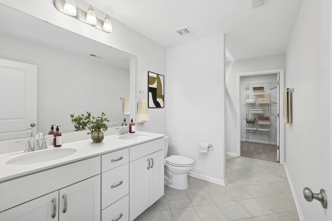 Upgrade Package Primary bath with dual sink vanity, granite countertops, and tile flooring
