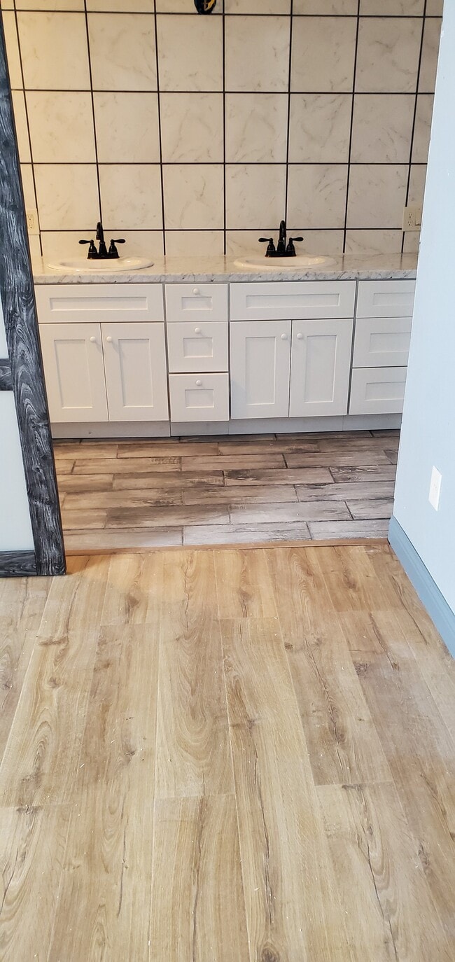 Tile floor and walls in Master Restroom and walking shower
