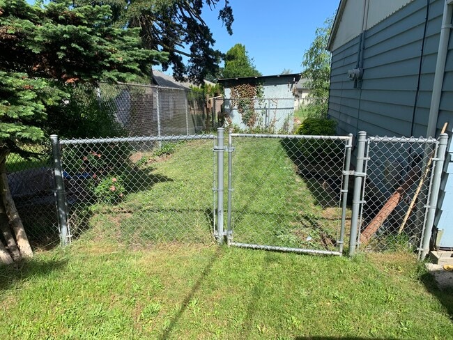 This is the side yard - deck is located off the back of the unit. - 2636 NE 111th Ave