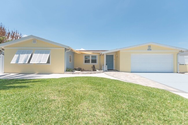 Building Photo - Live the ultimate Space Coast waterfront lifestyle at this stunning beachside canal home in Satel...