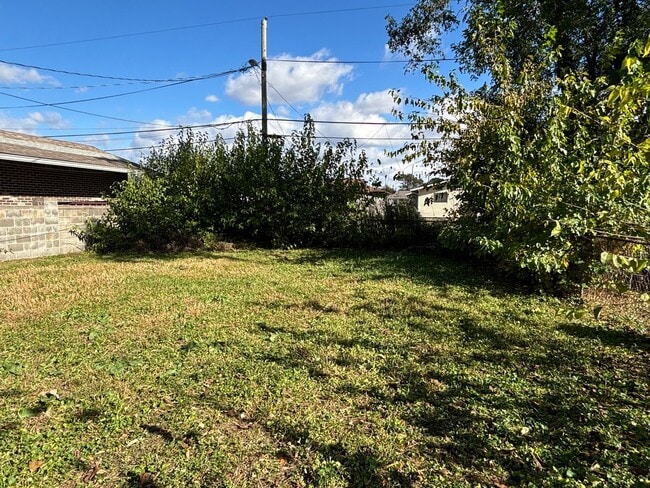 Photo - 4 Bed, 1.5 Bath Pet-Friendly Home with Fully Fenced Backyard