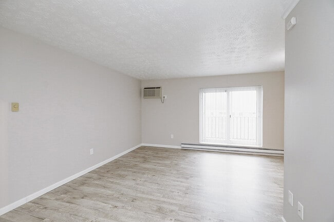 View of Living Room with Balcony - The Evalee Apartments
