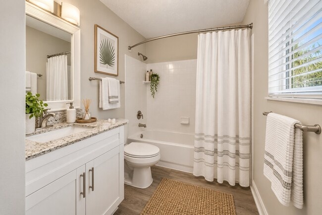 Indulge in the serene ambiance of Sanctuary Cove Apartments, featuring a stylish bathroom with modern finishes and inviting decor. Relax and unwind in your personal oasis. Schedule your tour today and envision your new life here!