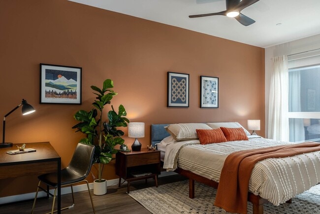 Bedroom with a sliding glass door and private balcony access - AMLI Redmond Way