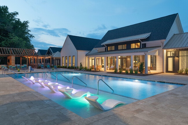 Experience tranquility and style at this luxurious poolside retreat, perfect for evening relaxation. - Lemmond Farm
