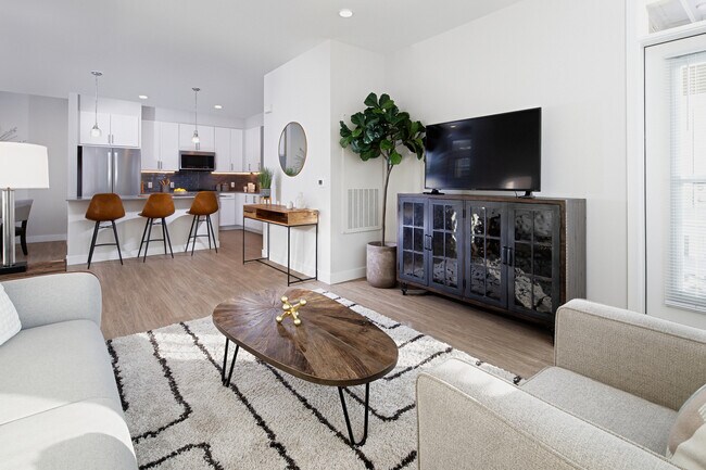 Renovated Package II kitchen, dining, and living areas with hard surface flooring