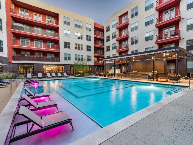 Enjoy the resort-style pool at Modera EaDo, featuring a spacious sunledge and serene water features for ultimate leisure. - Modera EaDo