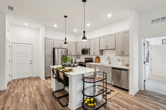 Enjoy cooking and relaxing in your spacious kitchen with beautiful finishes and lots of storage. - Tapestry University Park Apartments