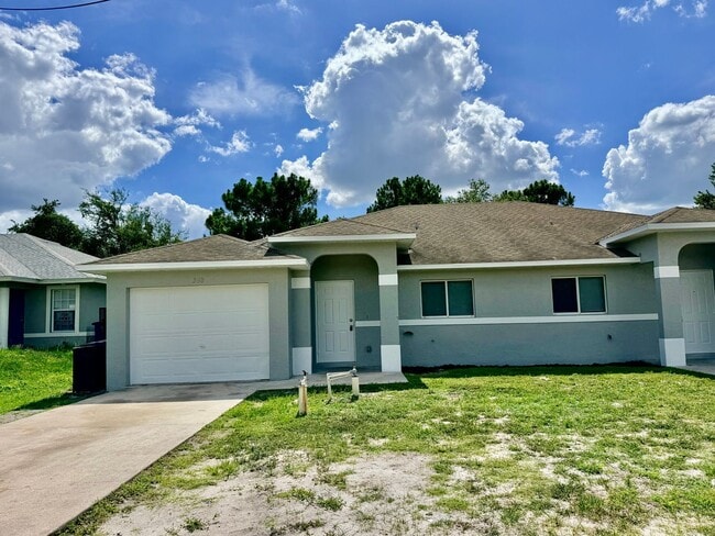 Building Photo - Charming 3BR/2BA Lehigh Acres Duplex with 1-Car Garage | Lawn Care & Salt Service Included