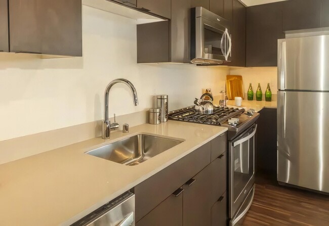 Caesarstone counters and a gas range come standard in these kitchens.