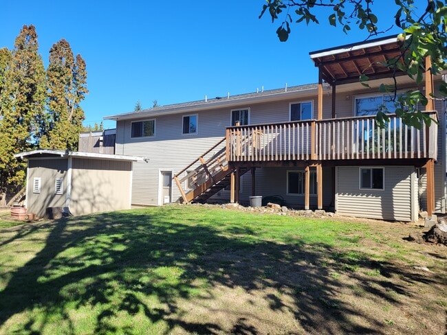 back side view of house showing children'splayhouse underneath deck - 5095 SW 163rd Ave