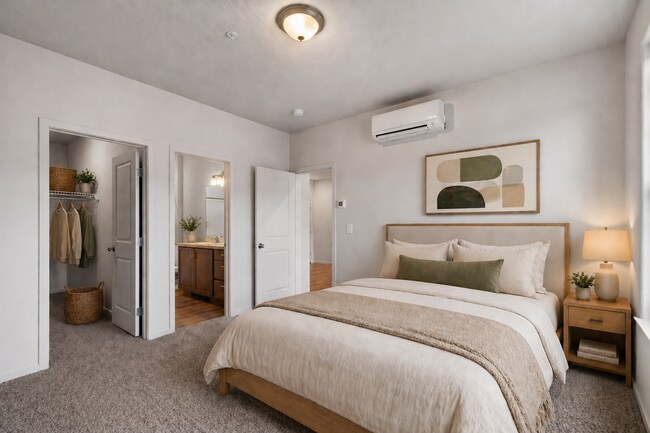 Elegant bedroom with walk-in closet, en suite bathroom, plush carpeting, and soft lighting creating a cozy ambiance.