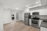 Modern kitchen with stainless steel appliances and patio access