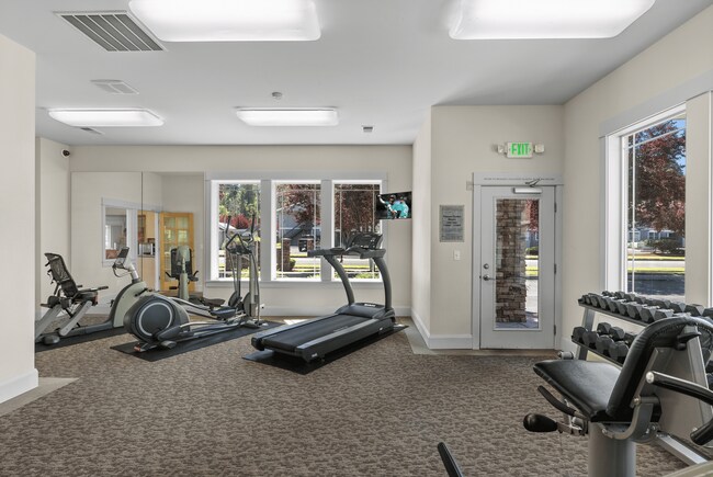 Fully equipped fitness center with cardio, strength machines, and free weights.