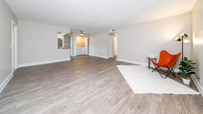 Thoughtfully updated with stylish flooring and a spacious layout, this living room offers the ideal blend of comfort and functionality.